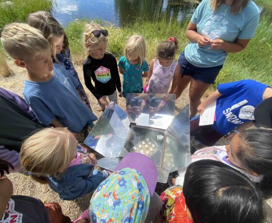 Campers work on a science project together.