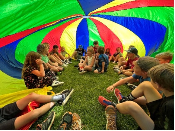 Junior Mountaineer Campers play outside.