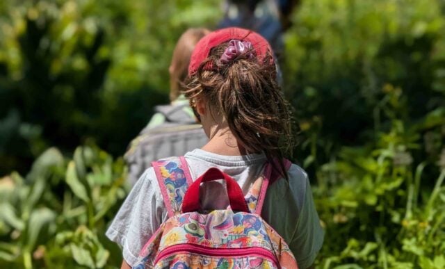 Junior Mountaineer Campers hike through the forest.