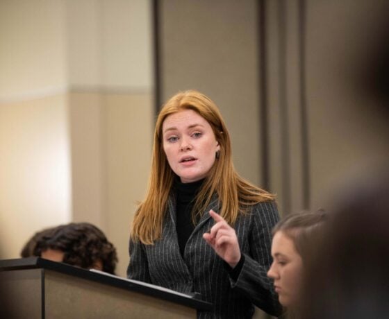 A student gives the prosecution team's opening argument at a mock trial event.