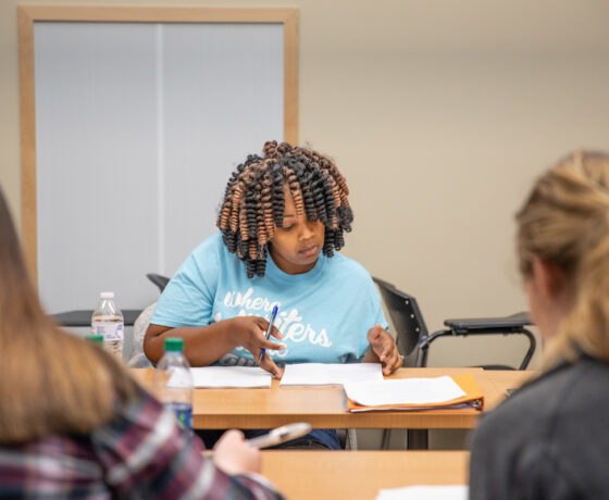 A girl works on her class work.