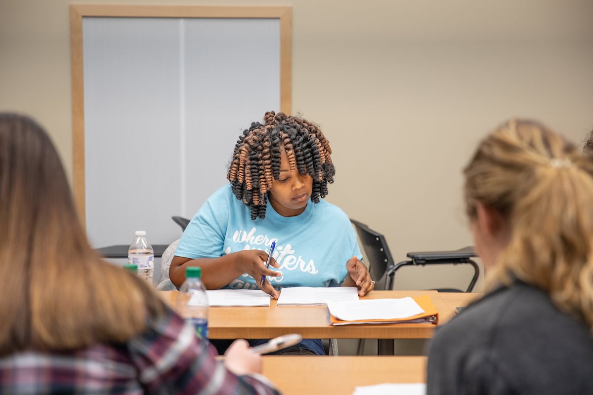 A girl works on her class work.