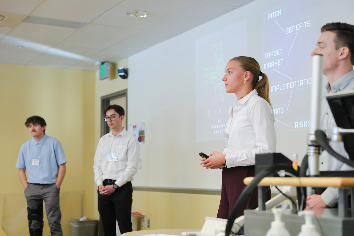 Prospective students participating in Borick Scholars Weekend present their projects to a panel of business professors.