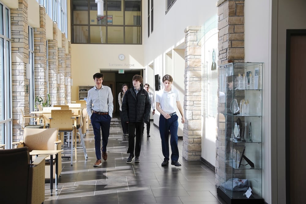 Prospective students participating in Borick Scholars Weekend walk through the business building.