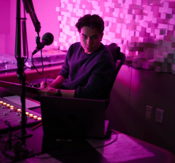 Kai Vong sits in the KWSB studio during his jazz DJ show for the radio station.