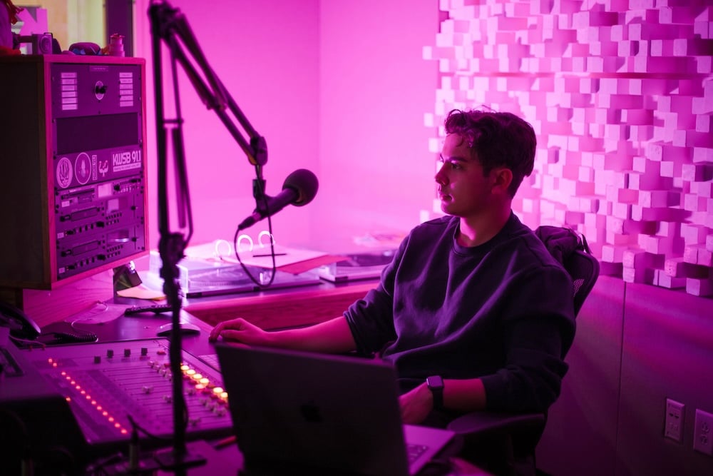 Kai Vong sits in the KWSB studio during his jazz DJ show for the radio station.