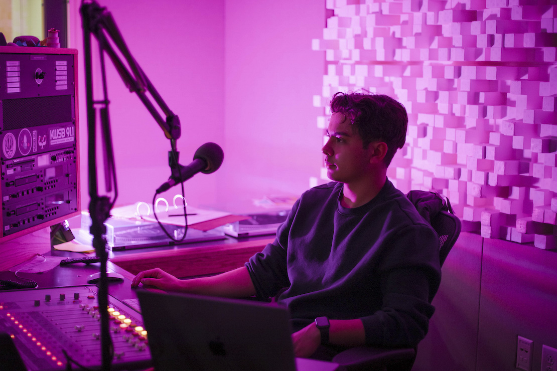 Kai Vong sits in the KWSB studio during his jazz DJ show for the radio station.