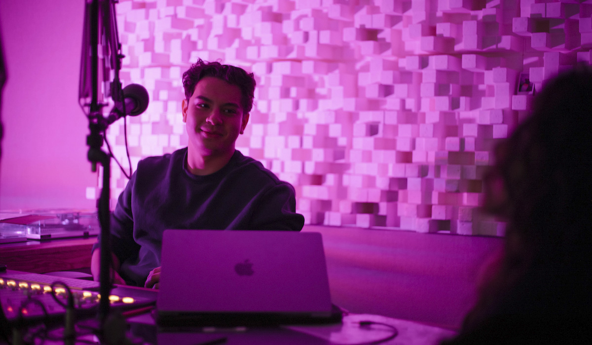 Kai Vong sits in the KWSB studio during his jazz DJ show for the radio station.