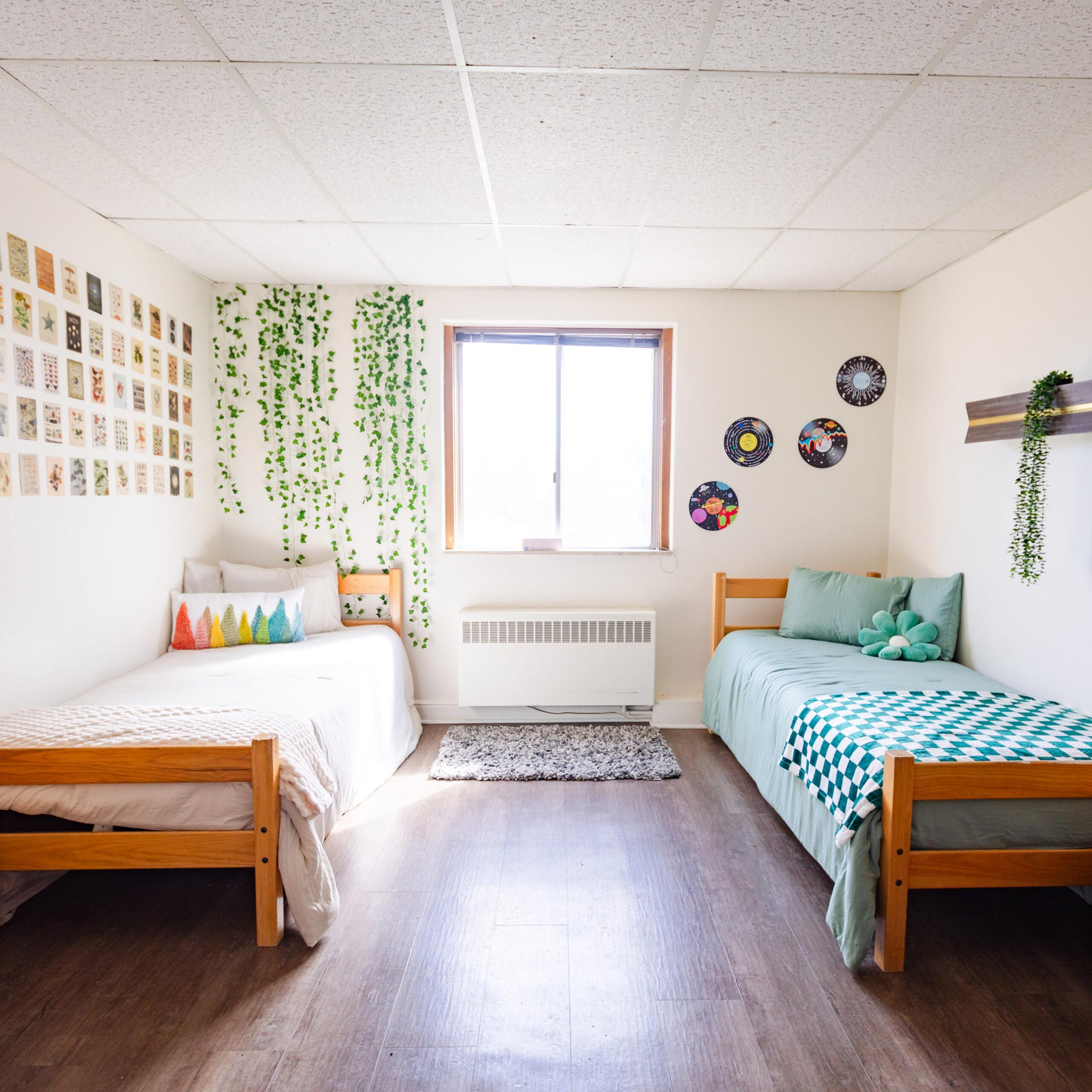 A dorm room with two beds and two dressers inside Ute Hall.