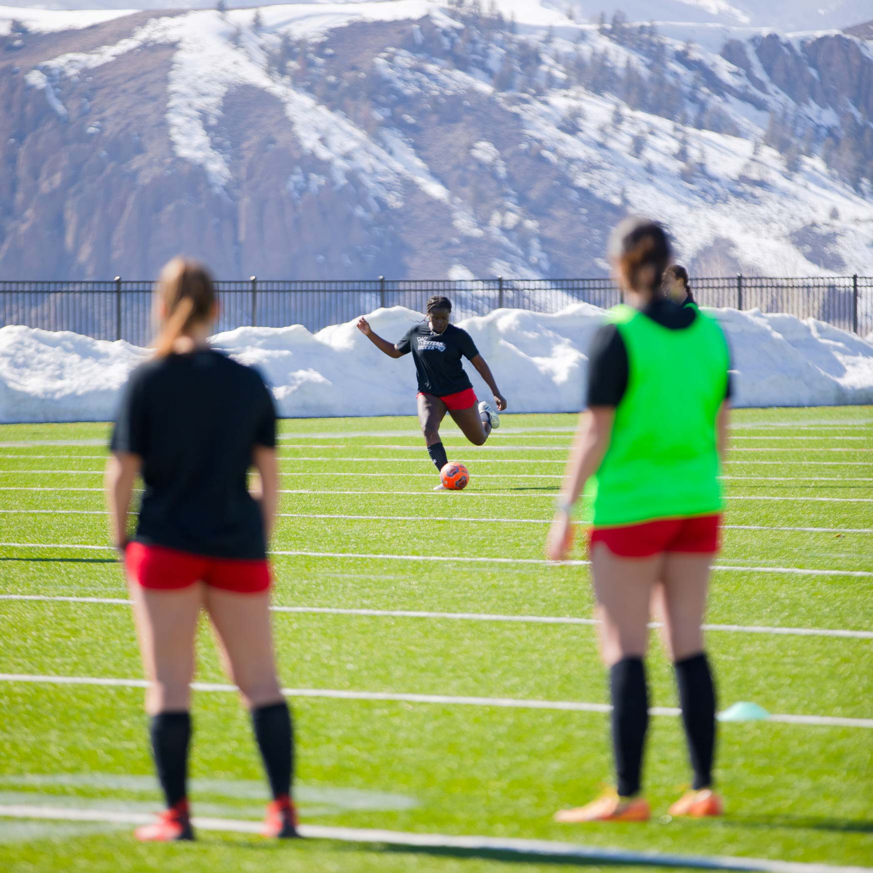 Natasha Kasozi winds up to kick the soccer ball during a drill at practice with the NCAA Women's Soccer Team.