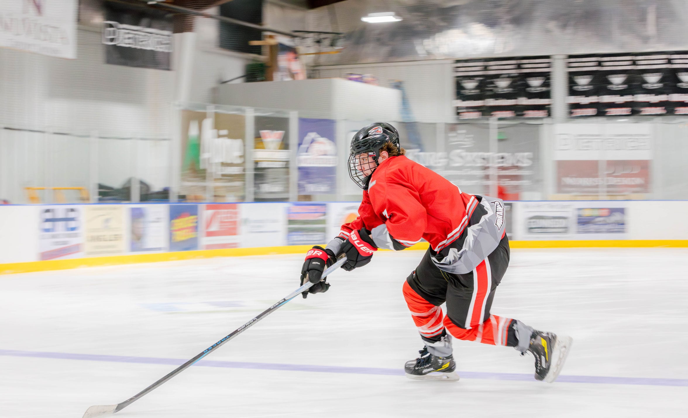 A western hockey player skating to the puck at practice.