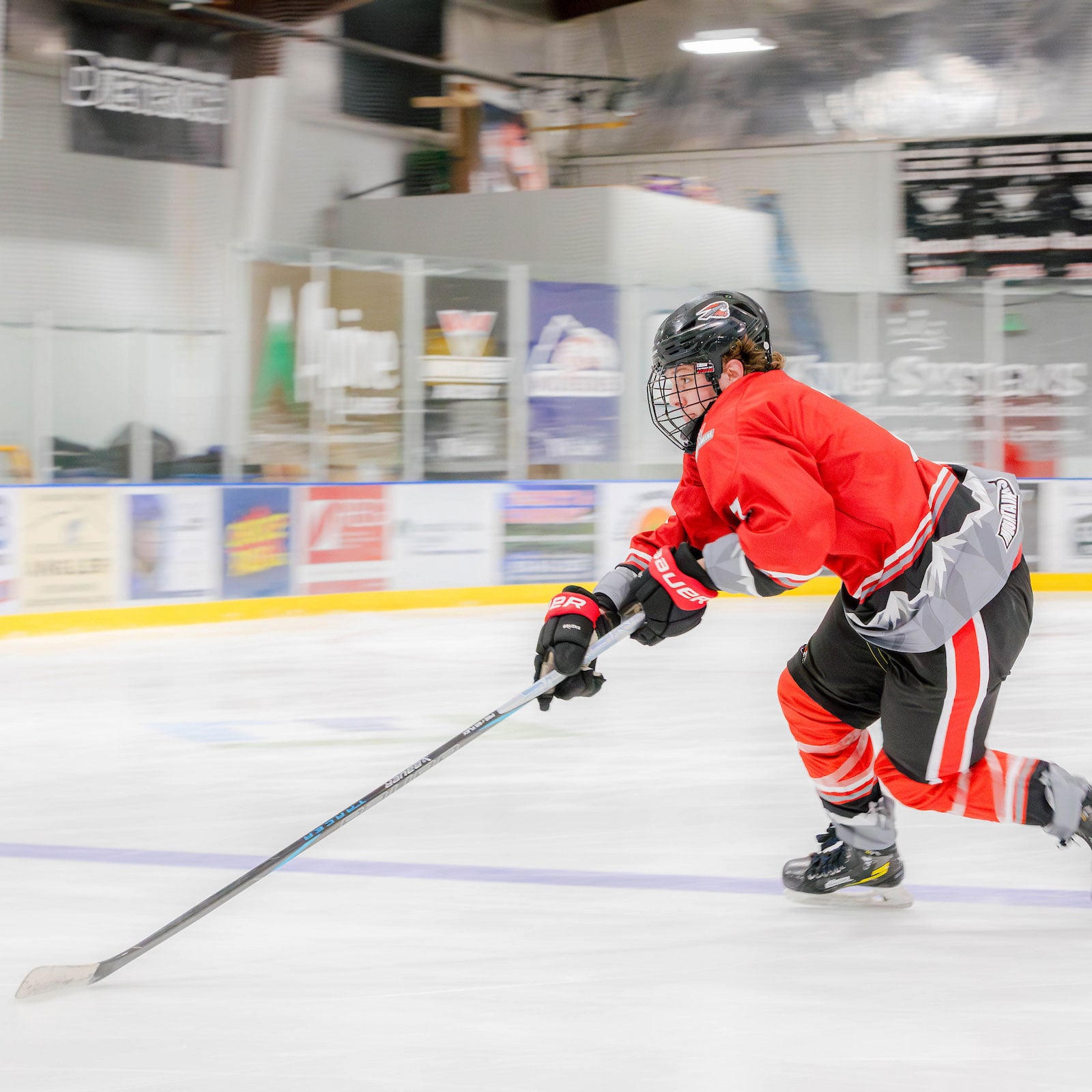 A western hockey player skating to the puck at practice.