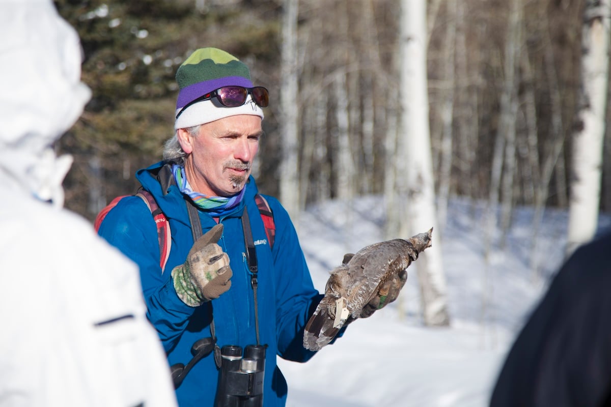 Dr. Pat Magee holds a taxidermied bird and gives a lecture while on a field trip with his ornithology class at Mill Creek.