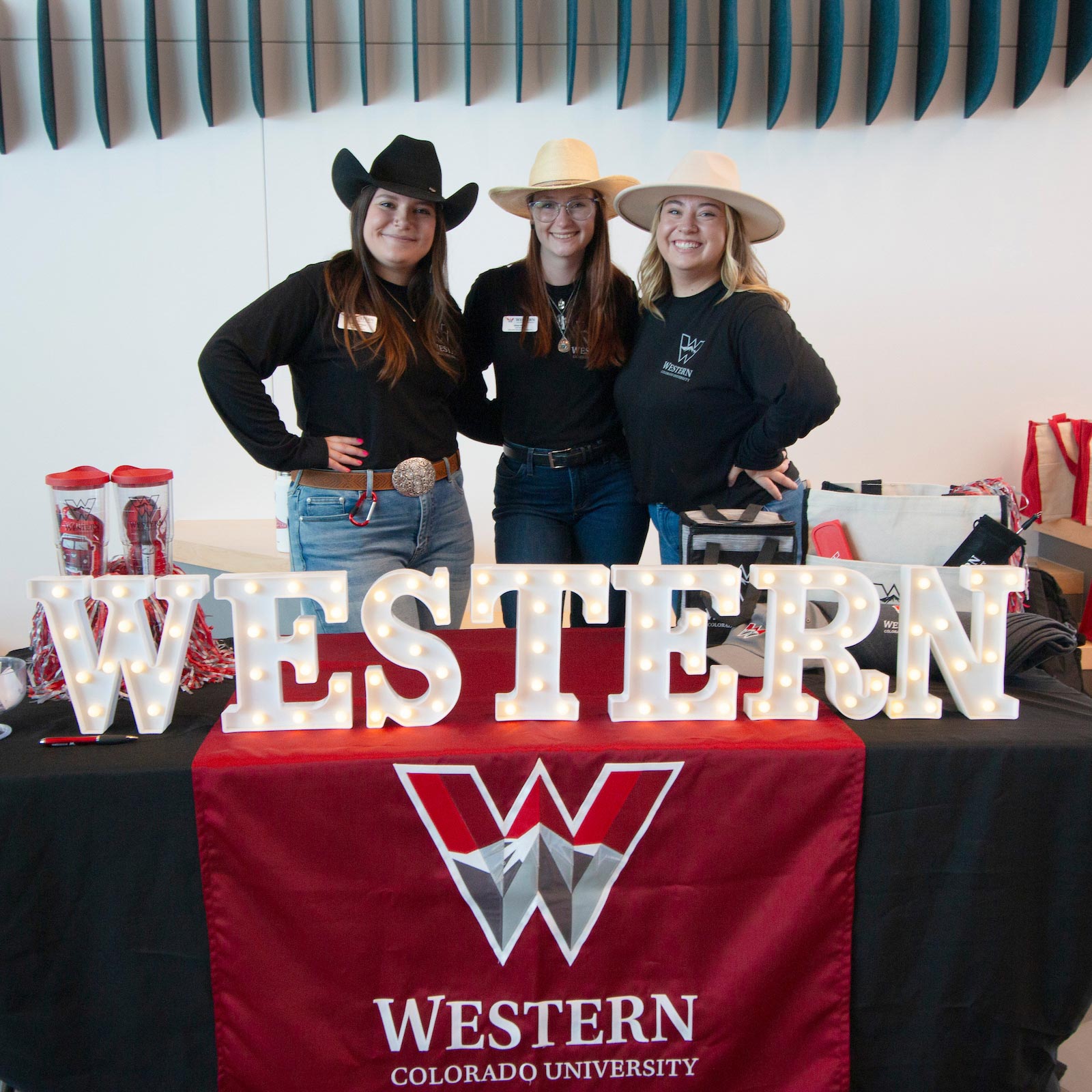 A few members of the admissions team post for a photo at a table in the Rady Building.