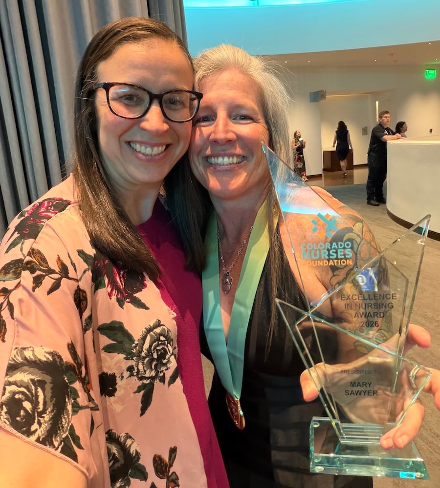 Dr. Mary Sawyer shows off her award with her colleague.