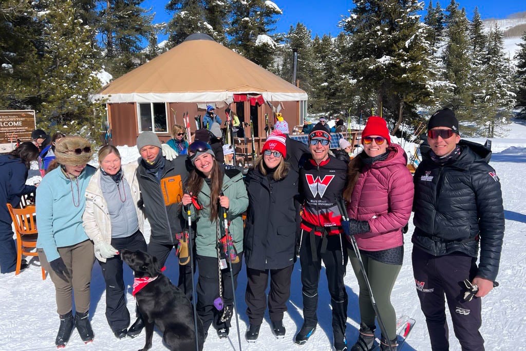 Group photo of people in front of a yurt.