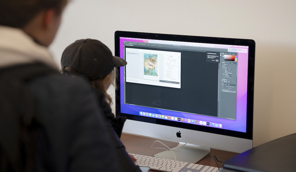 A couple of art students scan a painting into Photoshop during the Pathfinder Magazine Submission Festival.