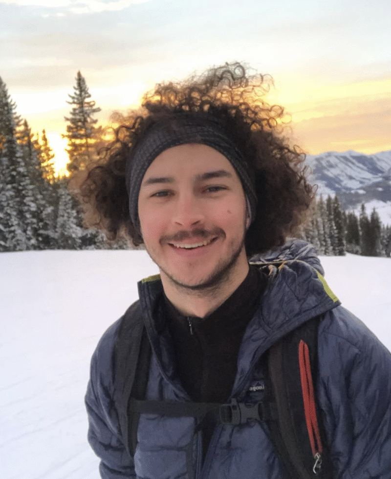 Headshot of Dylan Wood skinning up Mt. Crested Butte at sunset.