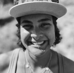 Headshot of Hayley Wood wearing a baseball hat.