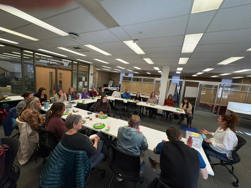 Adults fill a classroom.