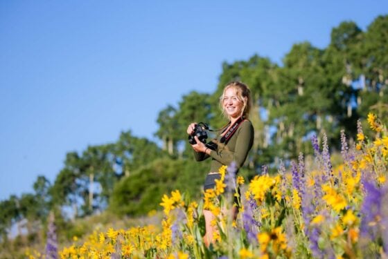 Student taking photos in flowers