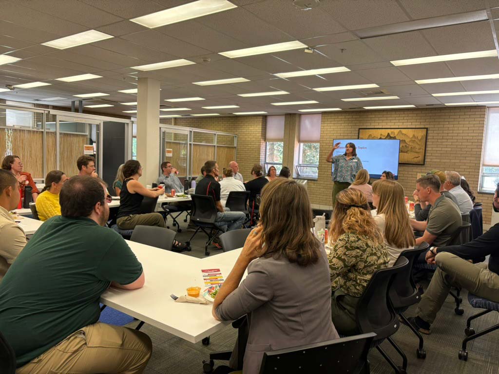 Adults fill a classroom.