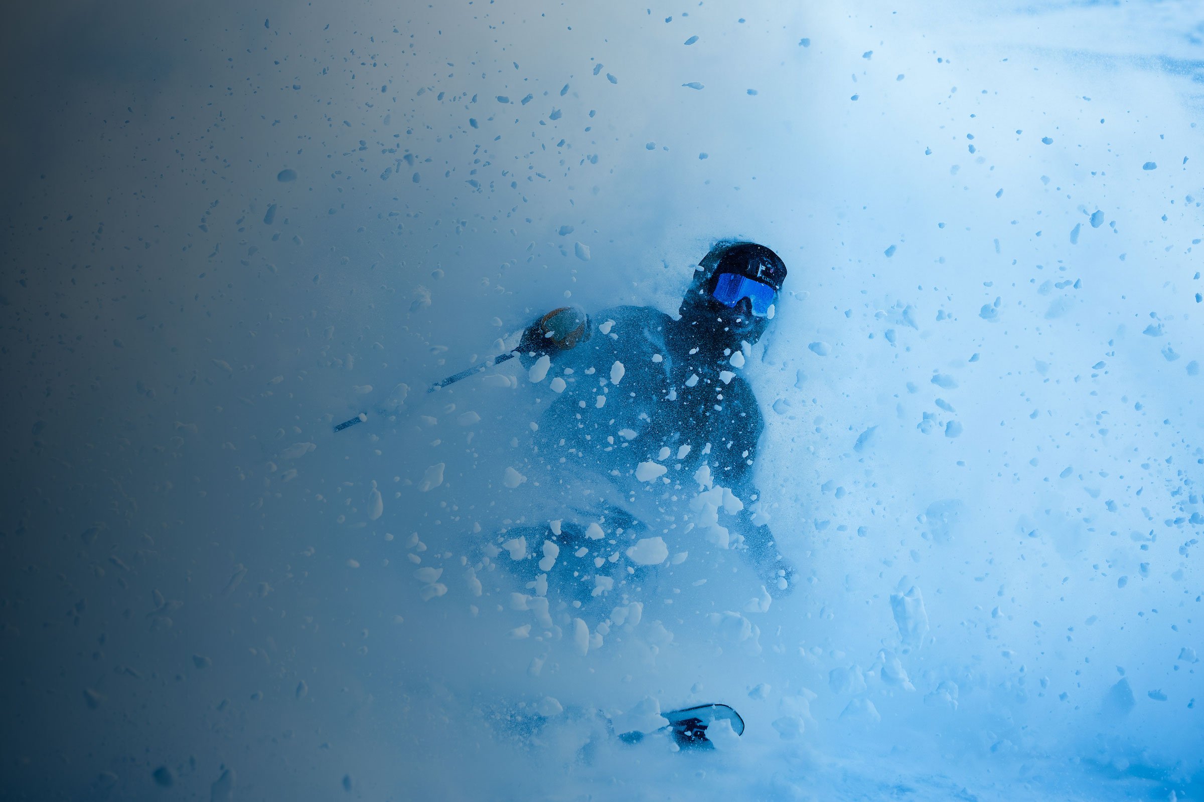 A skier skis out of a powder slash.