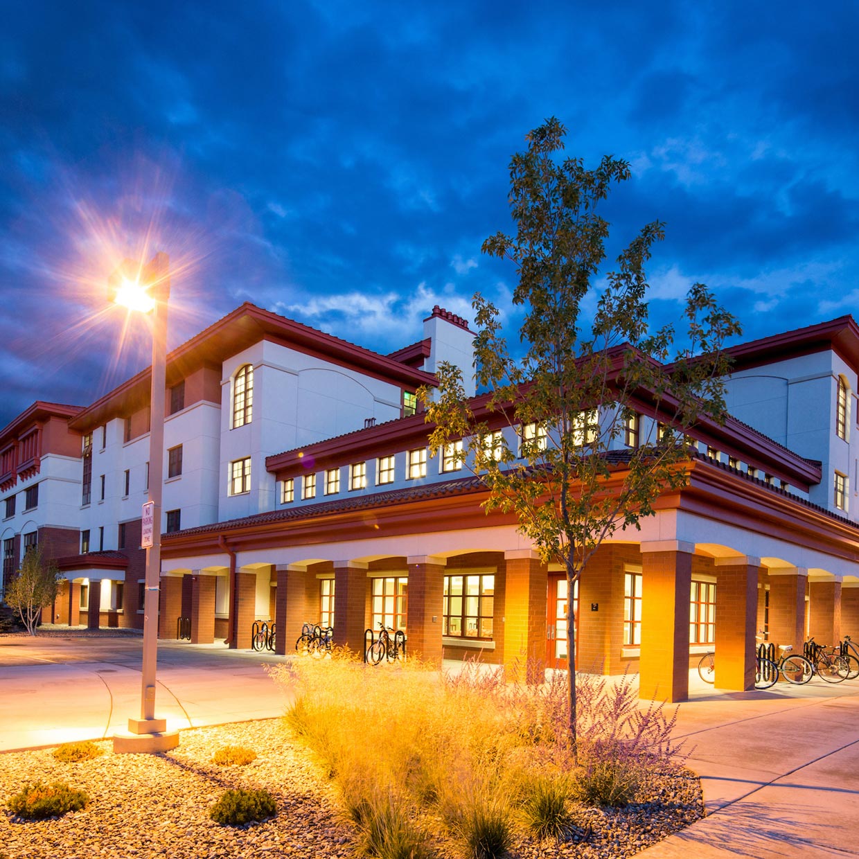 The exterior of Pinnacles Apartments at blue hour.