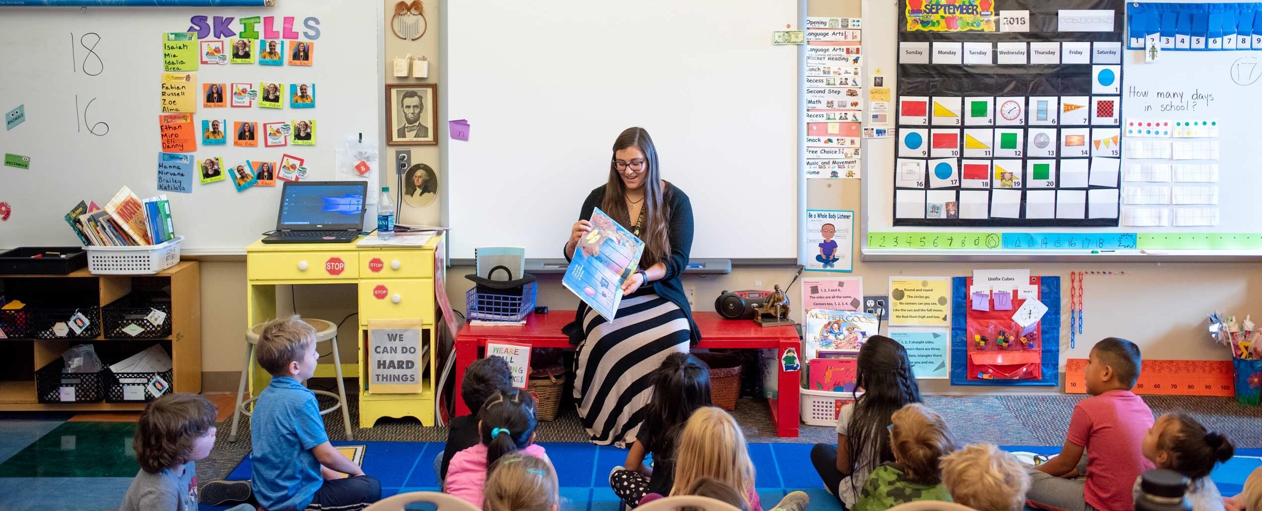 Alyeska Riker, female student teacher, reads to a group of kindergarteners.