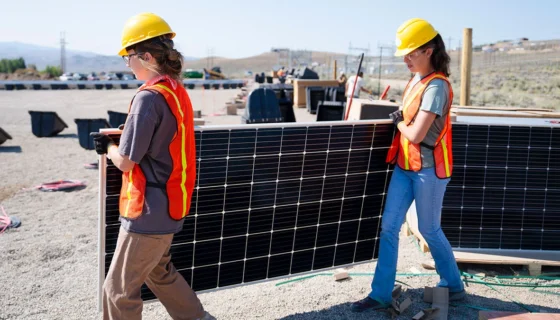 Students carry a solar panel.