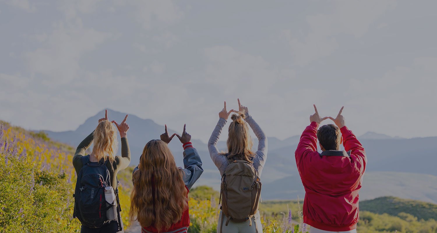 Students hold up the W with Teocalli in the background