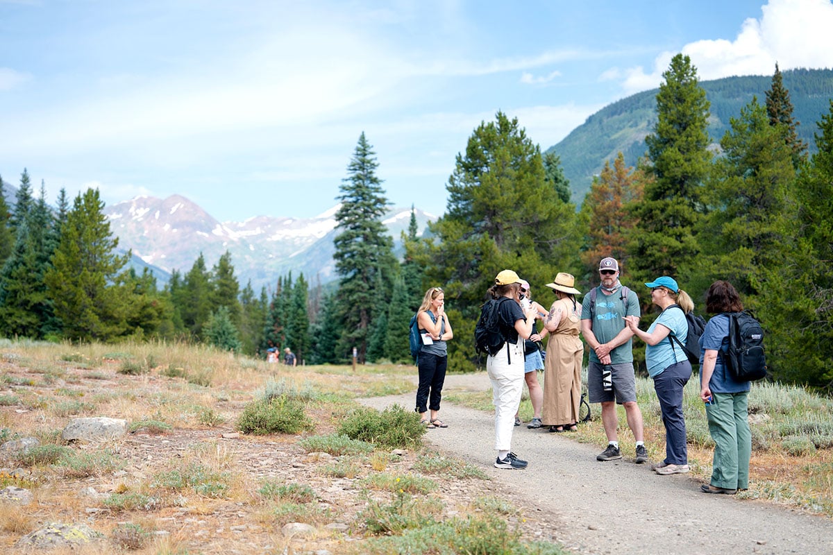 Graduate students and faculty converse while hiking on the Lower Loop Trail