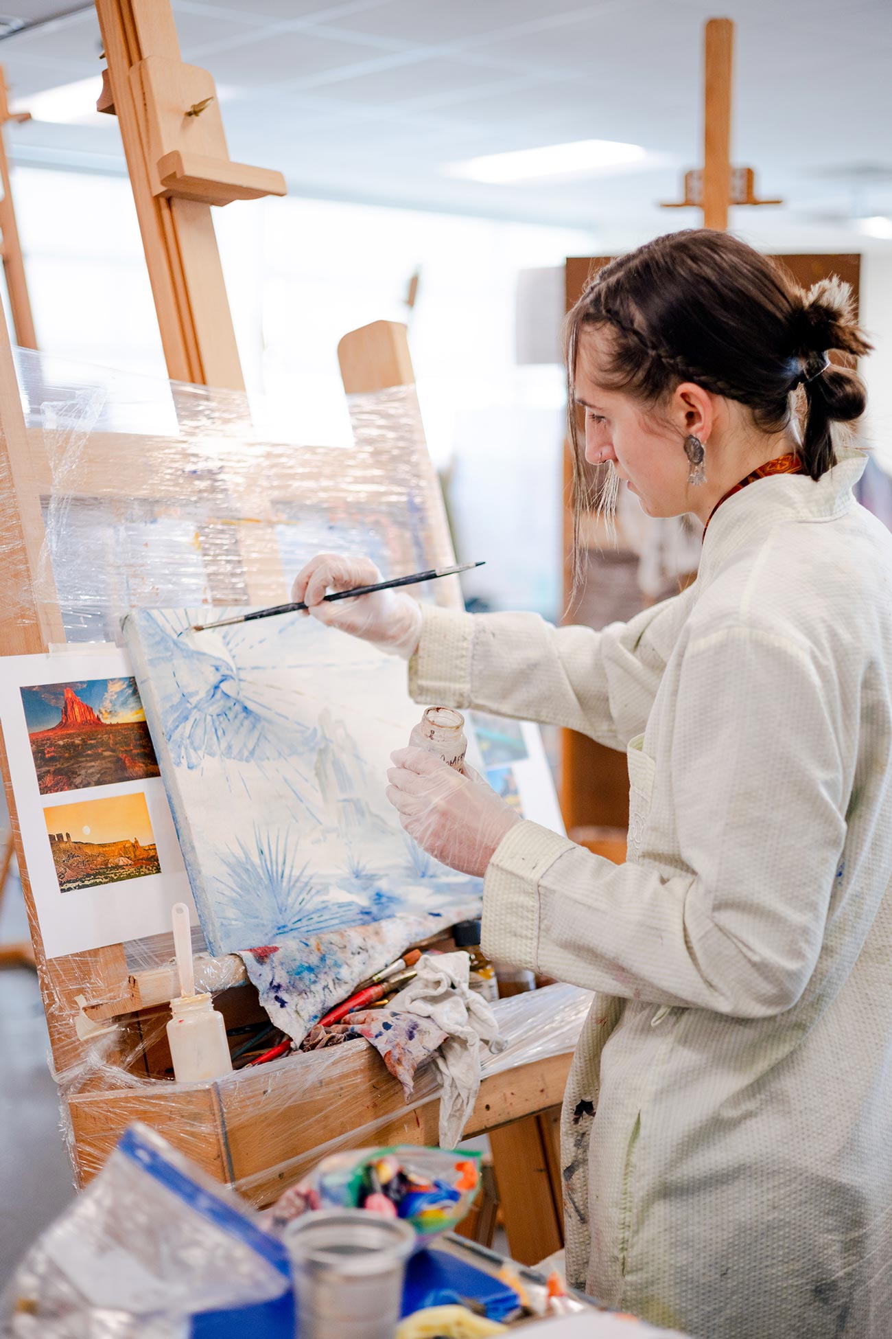 Student working on her vibrant oil painting