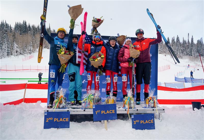 Posing on the podium of the race with a trophy.