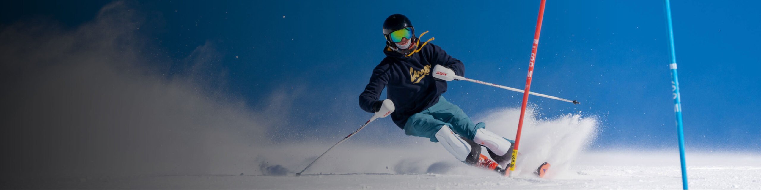 An athlete on the alpine ski team skis around a gate during practice at CBMR.