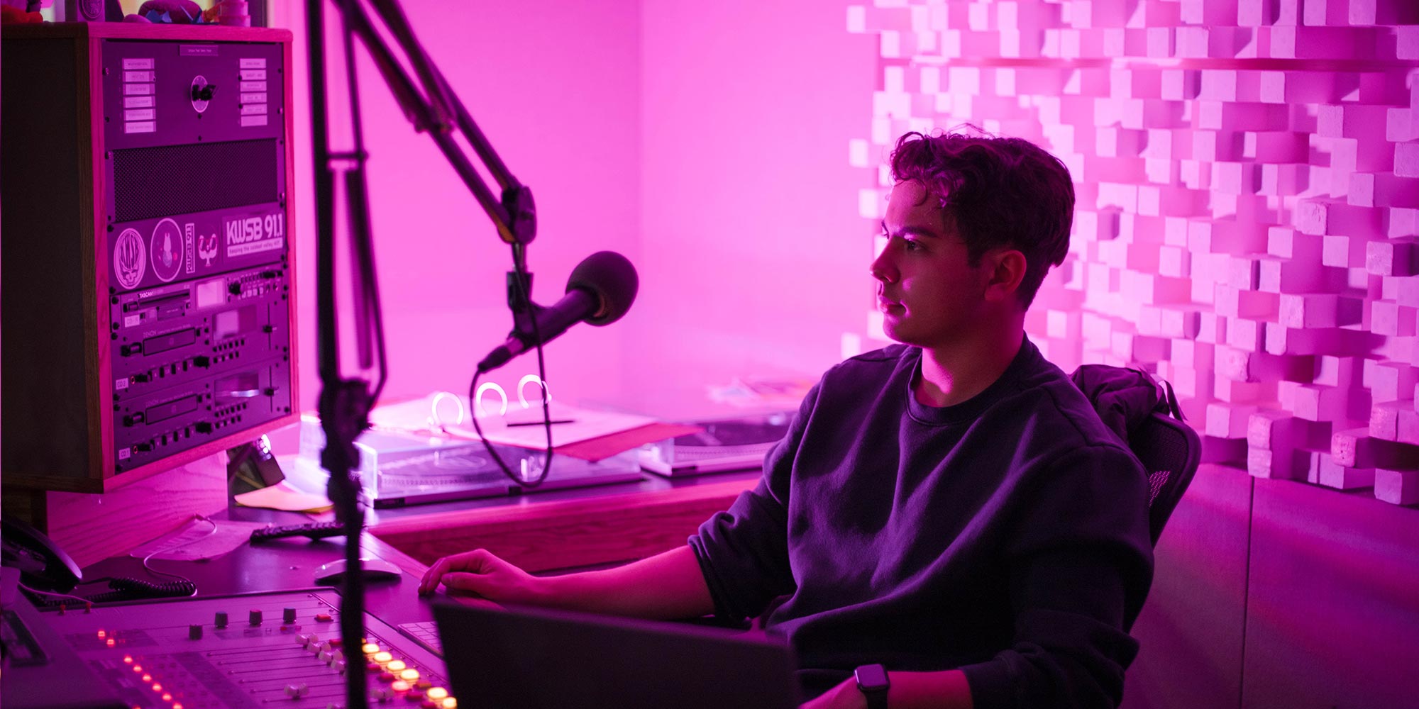Kai Vong sits in the KWSB studio during his jazz DJ show for the radio