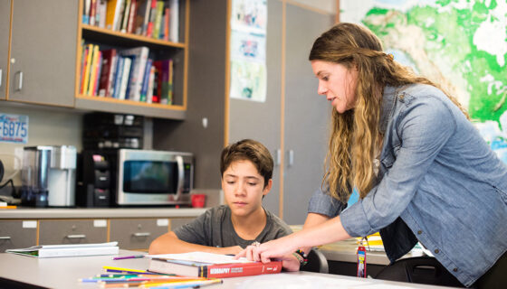 Student teacher Taylor Martin helping a student with class work