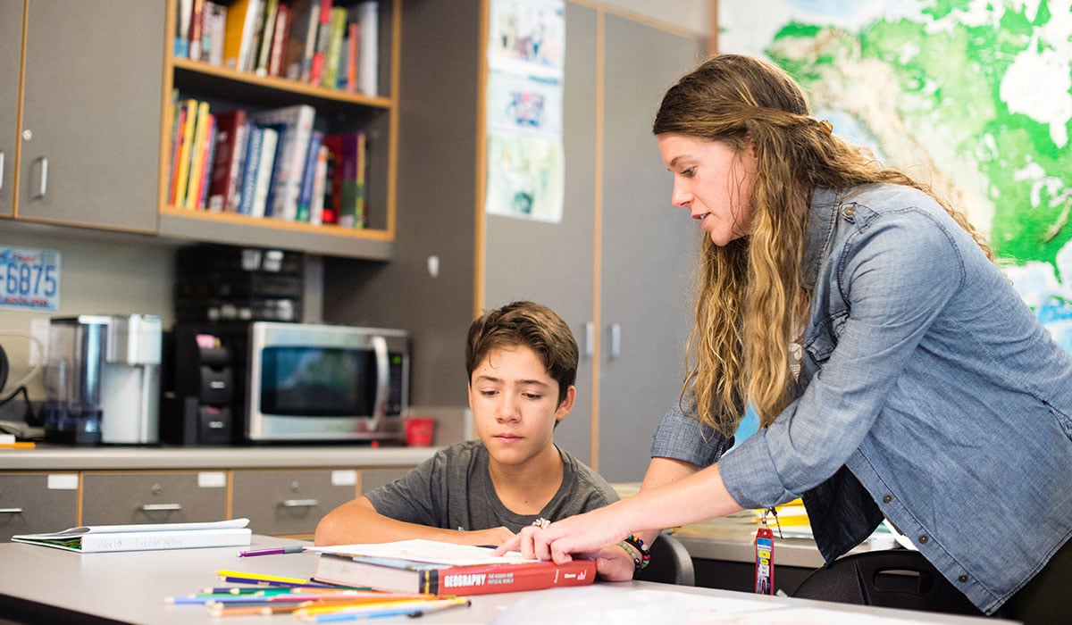Student teacher Taylor Martin helping a student with class work