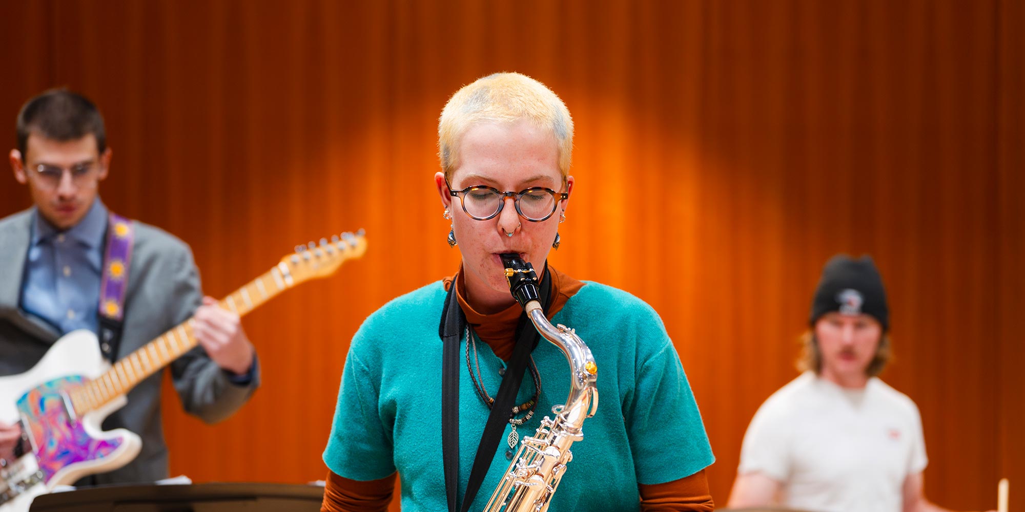 Student plays the saxophone during practice with the jazz band