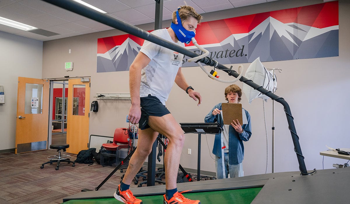 Student walks on an inclined treadmill simulating a trek to Mt. Everest base camp for data
