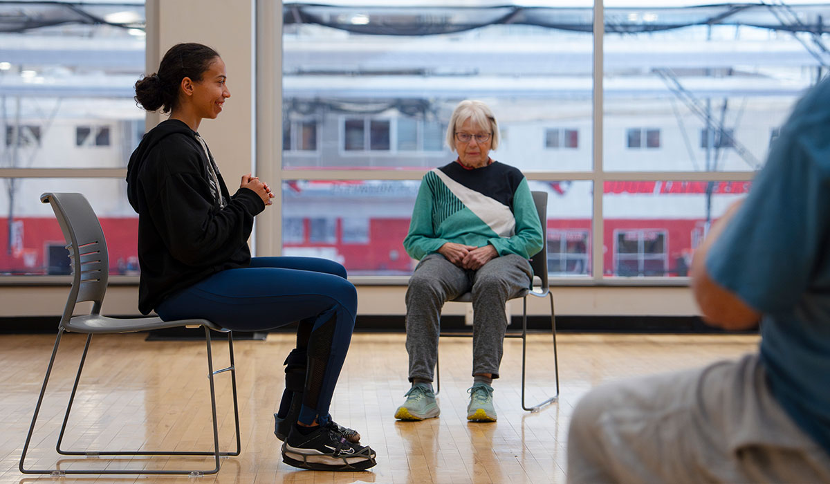 A student leads a balance class for senior community members for the Wellness Elevated program