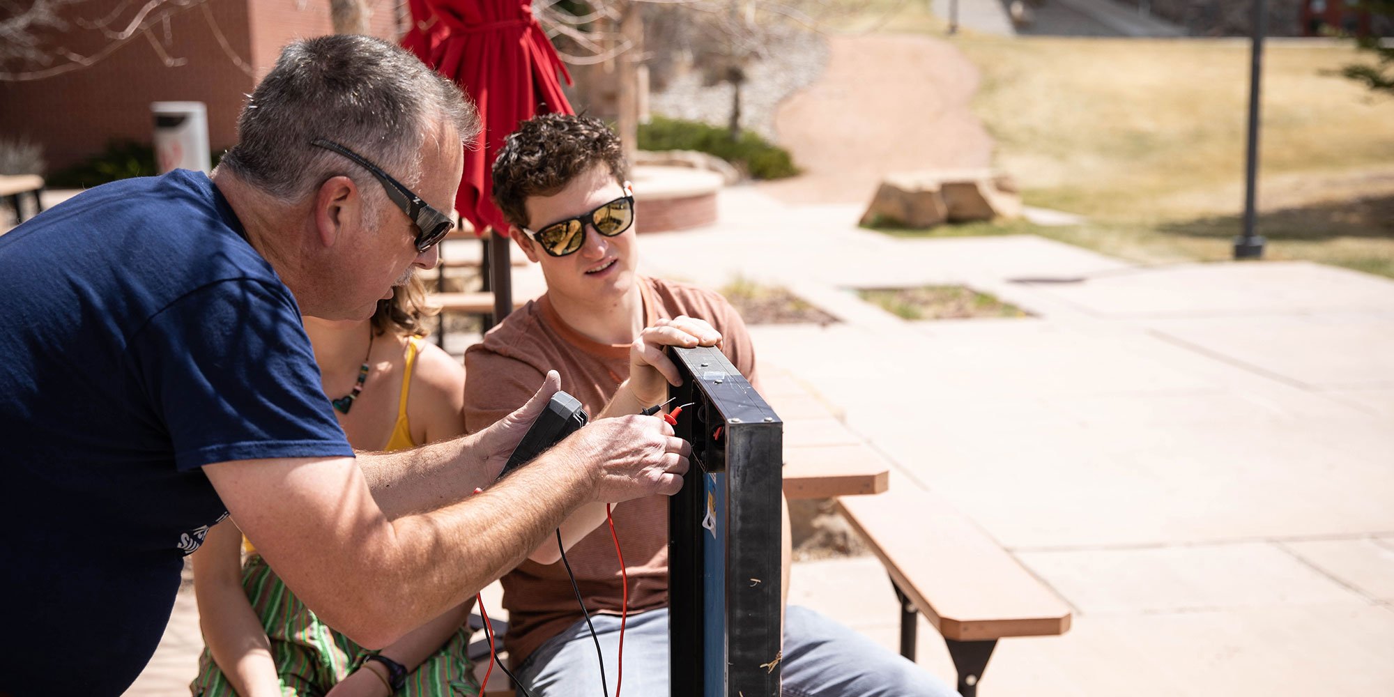 Rich Stromberg tests the voltage of a solar panel