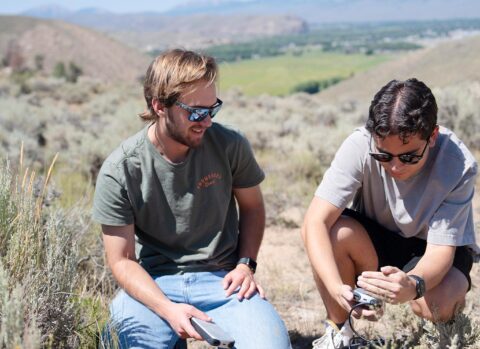 Two computer science students reading data off a sensor that records traffic passing at Hartman Rocks