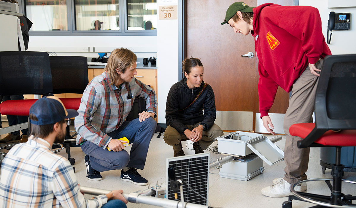 Four engineering students working on a project