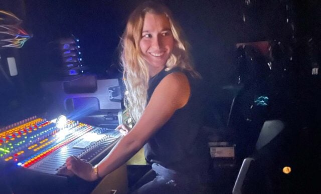 A girl works light backstage.
