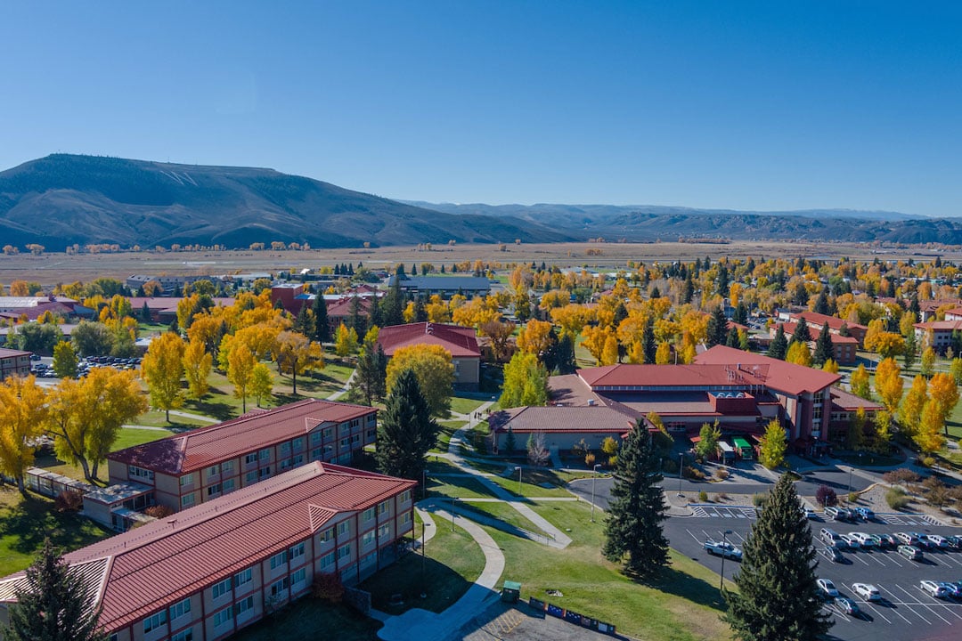 An aerial view of the Escalante Dorm Complex and the University Center with W Mountain in the background.