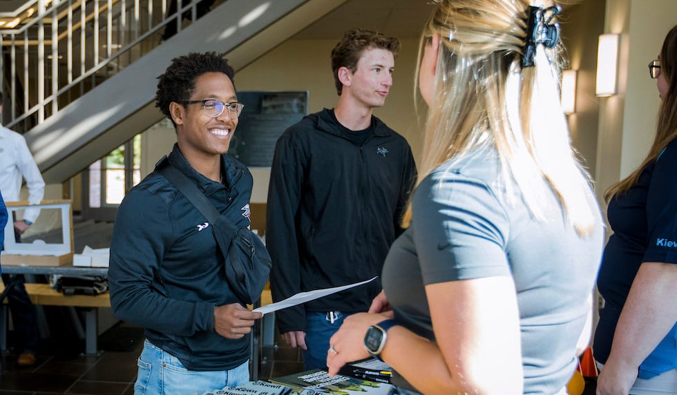 A student speaks to an employer at an energy management career fair.