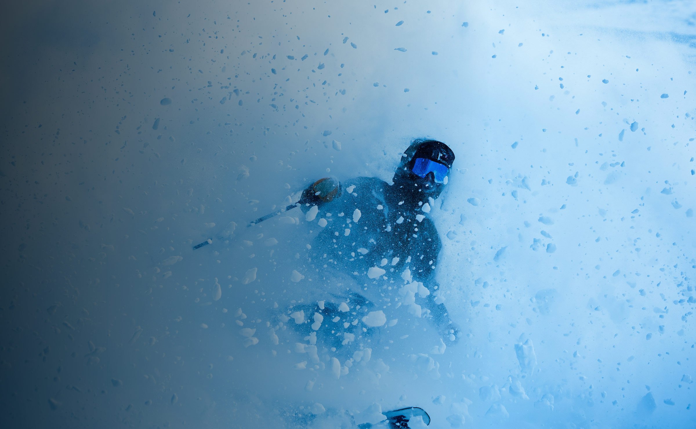 A skier skis out of a powder slash.