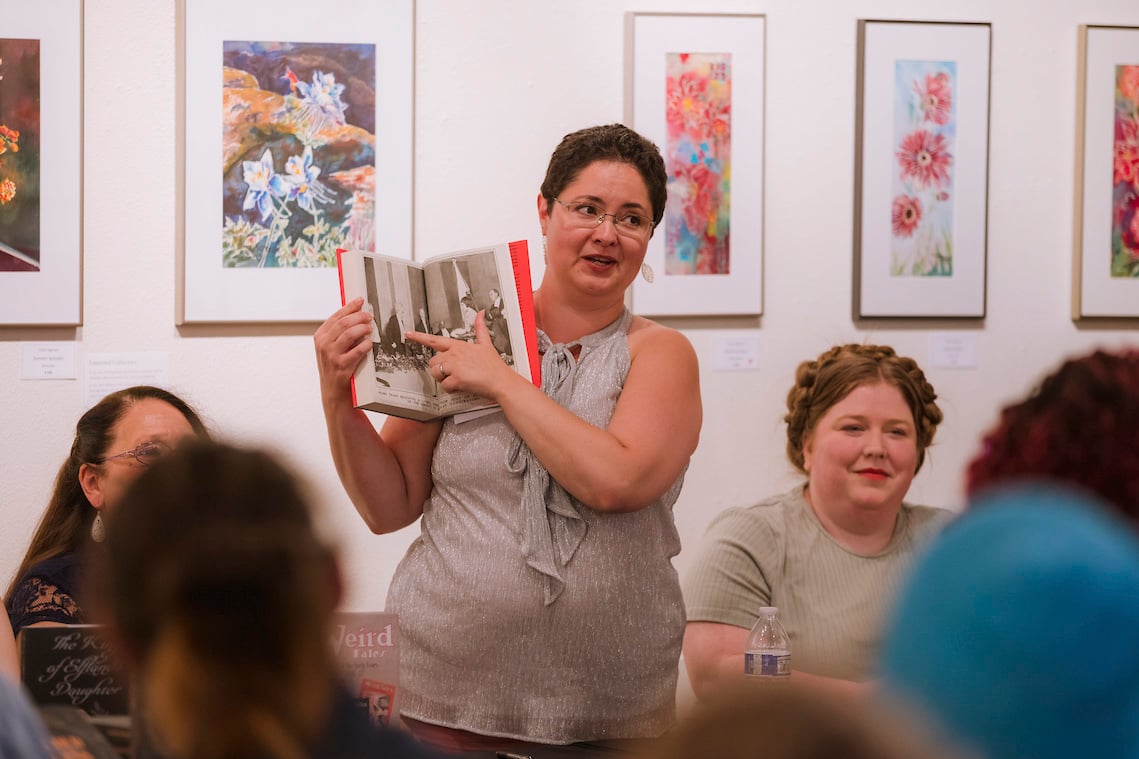 During a book signing, a grad student displays the work she helped publish.