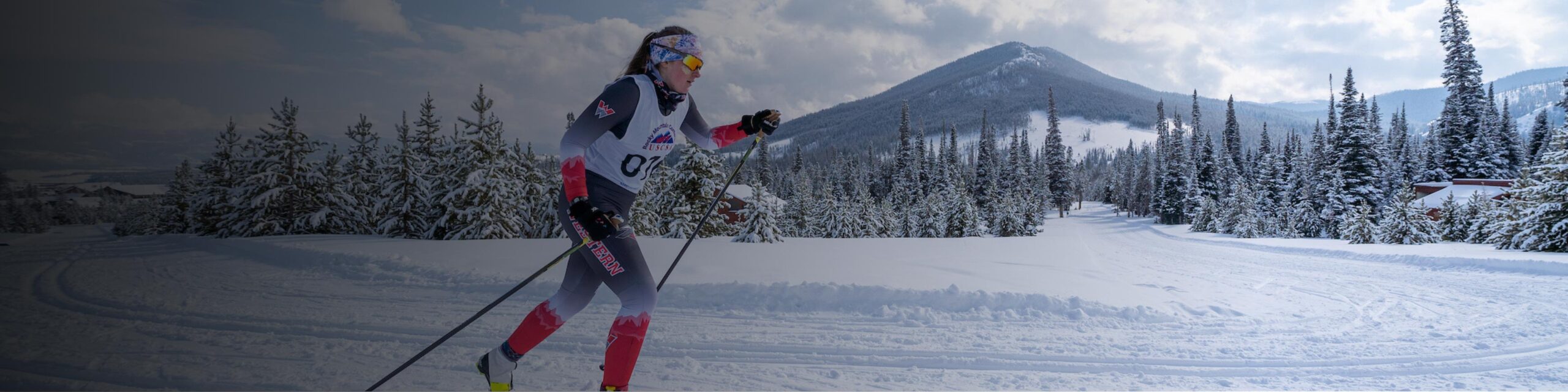 A Nordic skier classic skis in front of a mountain in Crested Butte.